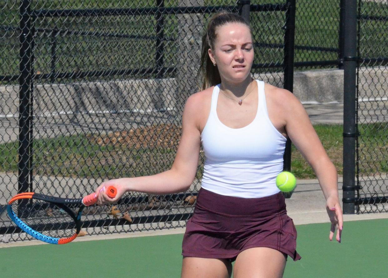 Holland Christian's Bria Lampen hits a forehand against Hamilton on Wednesday, April 12, at Holland Christian.