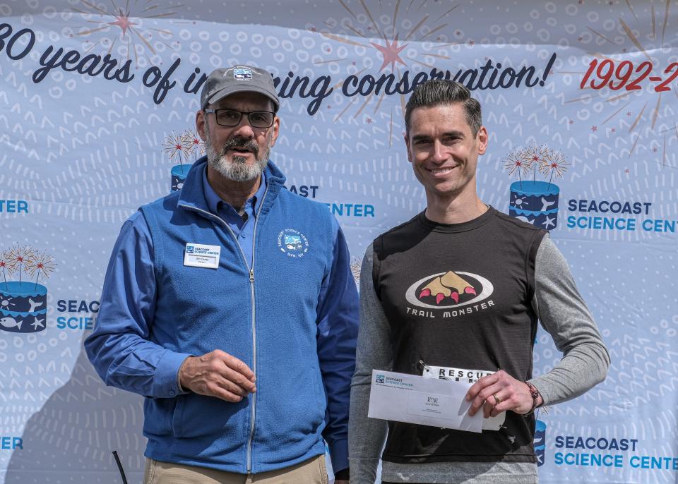 Seacoast Science Center held its 13th annual 5k Rescue Run: Race for Marine Mammals on April 30. Chief Executive Officer Jim Chase (left) presents an award to overall race winner Andy Kiburis, 37, of Hampstead, N.H., who crossed the finish line with a time of 17:50.