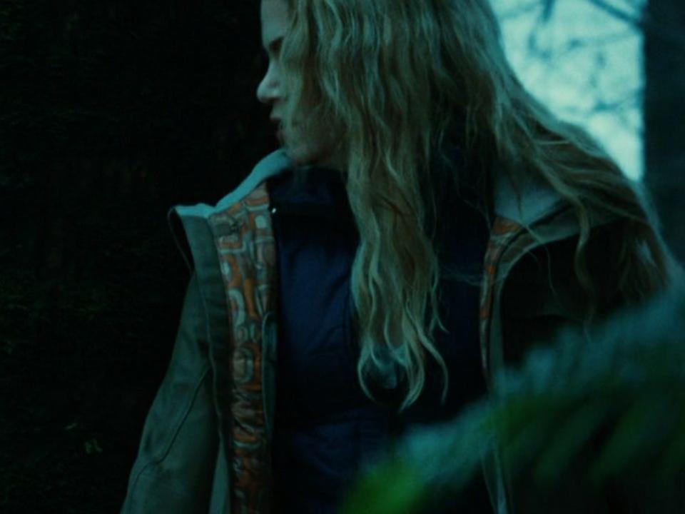 Rosalie rubbing against a tree in the forest in twilight