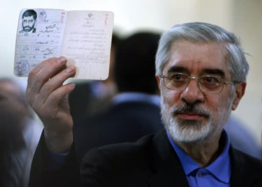 Mir Hossein Mousavi shows his identification card before registering his candidacy for the 2009 Iranian presidential election