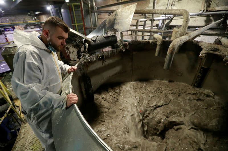 Valentyn Frechka, CEO of the "Re-leaf Paper" project, watches a paper production line at the Zhytomyr Cardboard Factory in Zhytomyr