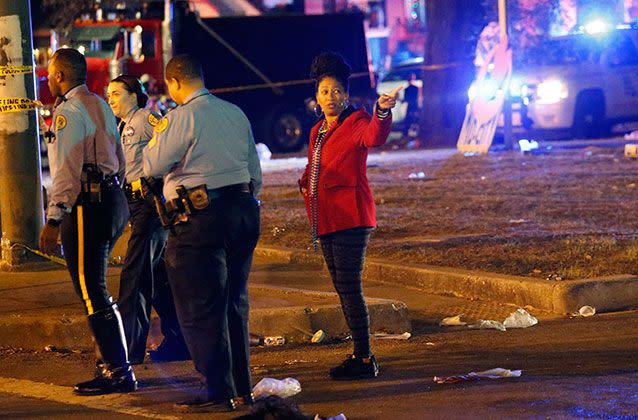 Police talk to a woman at the scene, where at least 28 were injured. Picture: AP/Gerald Herbert