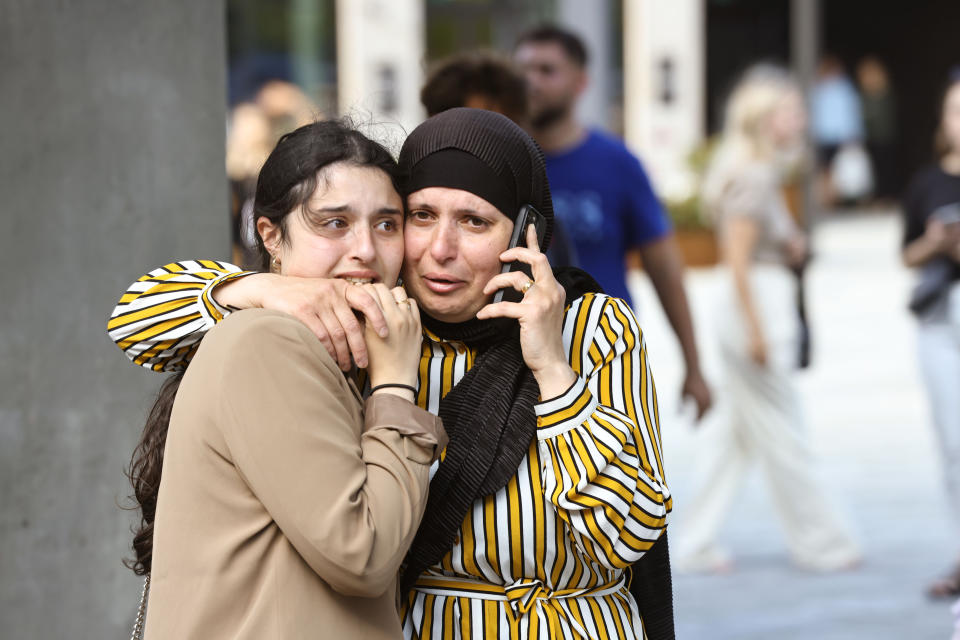 People evacuated from the Fields shopping center react, in Orestad, Copenhagen, Denmark, Sunday, July 3, 2022, after reports of shots fired. Danish police say several people have been shot at a Copenhagen shopping mall. Copenhagen police said that one person has been arrested in connection with the shooting at the Field’s shopping mall on Sunday. Police tweeted that “several people have been hit” but gave no other details. (Olafur Steinar Gestsson /Ritzau Scanpix via AP)