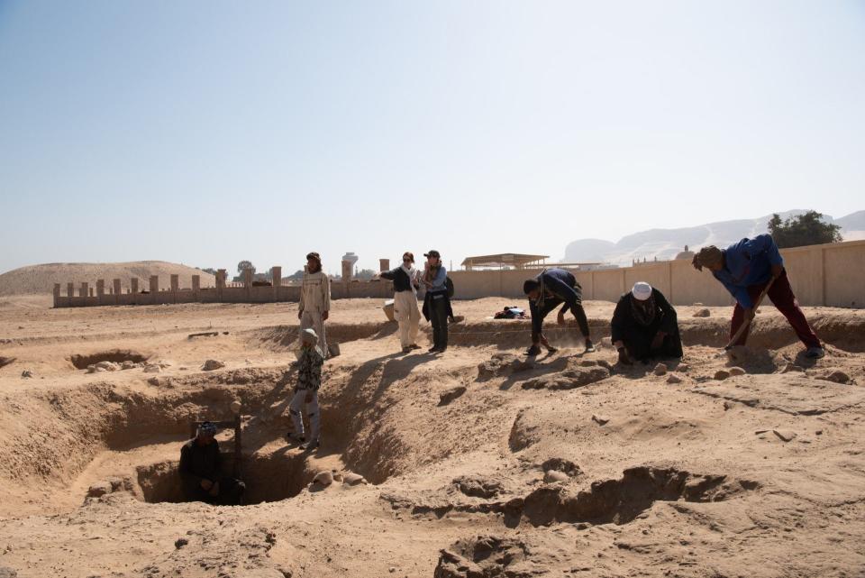 Smith-Sangster (center left) and Vischak (center right) discuss the next steps in excavations