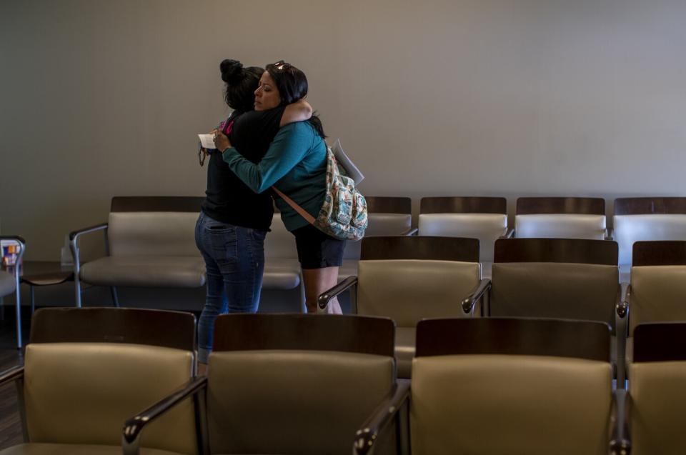 A teary staff member hugs a patient after informing her the clinic could no longer provide abortion services