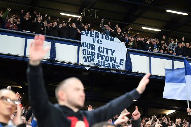 LIVERPOOL, ENGLAND - APRIL 24: Fans of Everton celebrate after the team's victory with a flag which reads 'Everton FC, Our City, Our People, Our Heart' in the Premier League match between Everton FC and Liverpool FC at Goodison Park on April 24, 2024 in Liverpool, England. (Photo by Michael Regan/Getty Images)