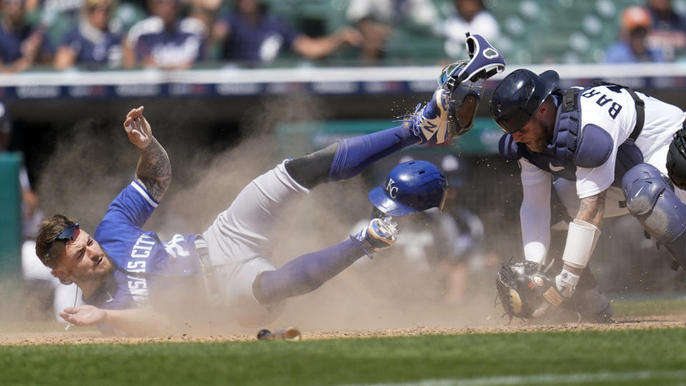 Detroit Tigers catcher Tucker Barnhart (15) tags Kansas City Royals' Kyle Isbel out at home plate in the ninth inning of a baseball game in Detroit, Sunday, July 3, 2022. (AP Photo/Paul Sancya)