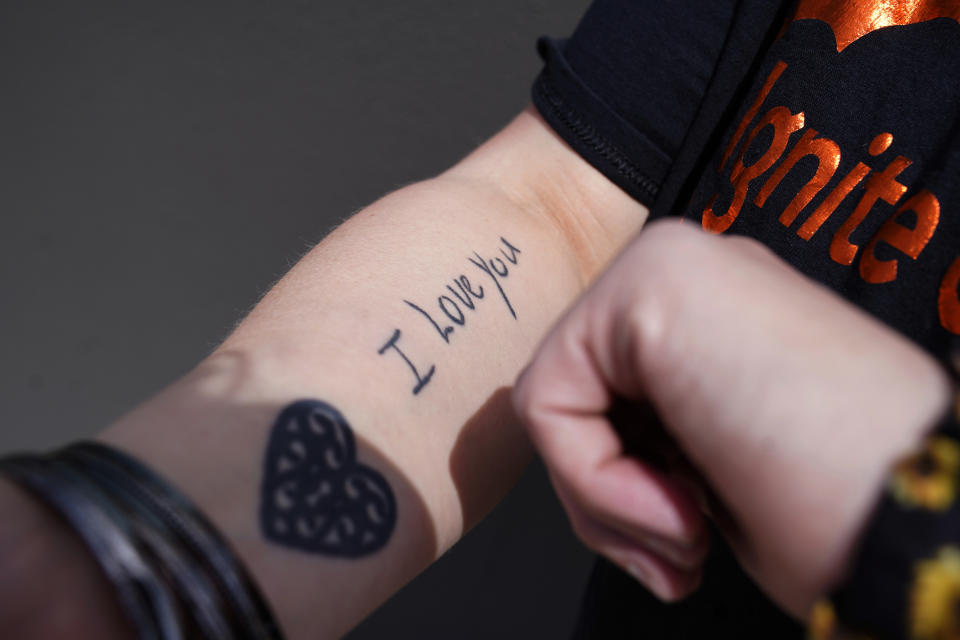 Carrie Shipp shows a tattoo on her arm for her children, April 2, 2021, in Irving, Texas. Shipp, whose 21-year-old son Matthew is incarcerated at Ruben M. Torres Unit in Texas, said her son decided not to get vaccinated out of fear and distrust of prison medical staff. Fewer than 20 percent of state and federal prisoners have received a COVID-19 vaccine, according to data collected by The Marshall Project and The Associated Press. “To have your child, someone you took care of be afraid of something that would protect them… I will lose sleep over it,” Shipp said. (AP Photo/LM Otero)