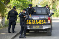 Police patrol El Estor in at the northern coastal province of Izabal, Guatemala, Monday, Oct. 25, 2021. The Guatemalan government has declared a month-long, dawn-to-dusk curfew and banned pubic gatherings following protests against a mining project. (AP Photo/Moises Castillo)