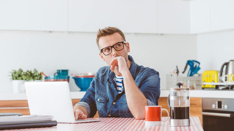 man thinking on laptop