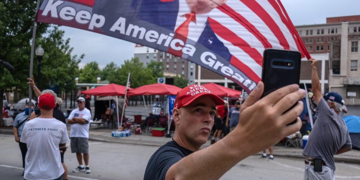 A Trump supporter takes a selfie near the BOK Center on June 19, 2020, in Tulsa, Oklahoma.