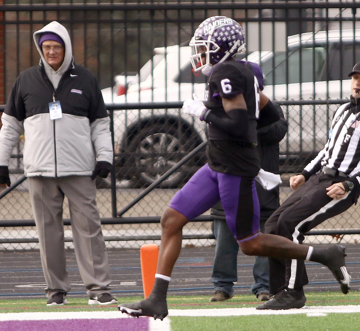 Former Mount Union head football coach Larry Kehres (left) watches as receiver Wayne Ruby Jr. crosses the goal line for a touchdown during last year's playoff game against Johns Hopkins.