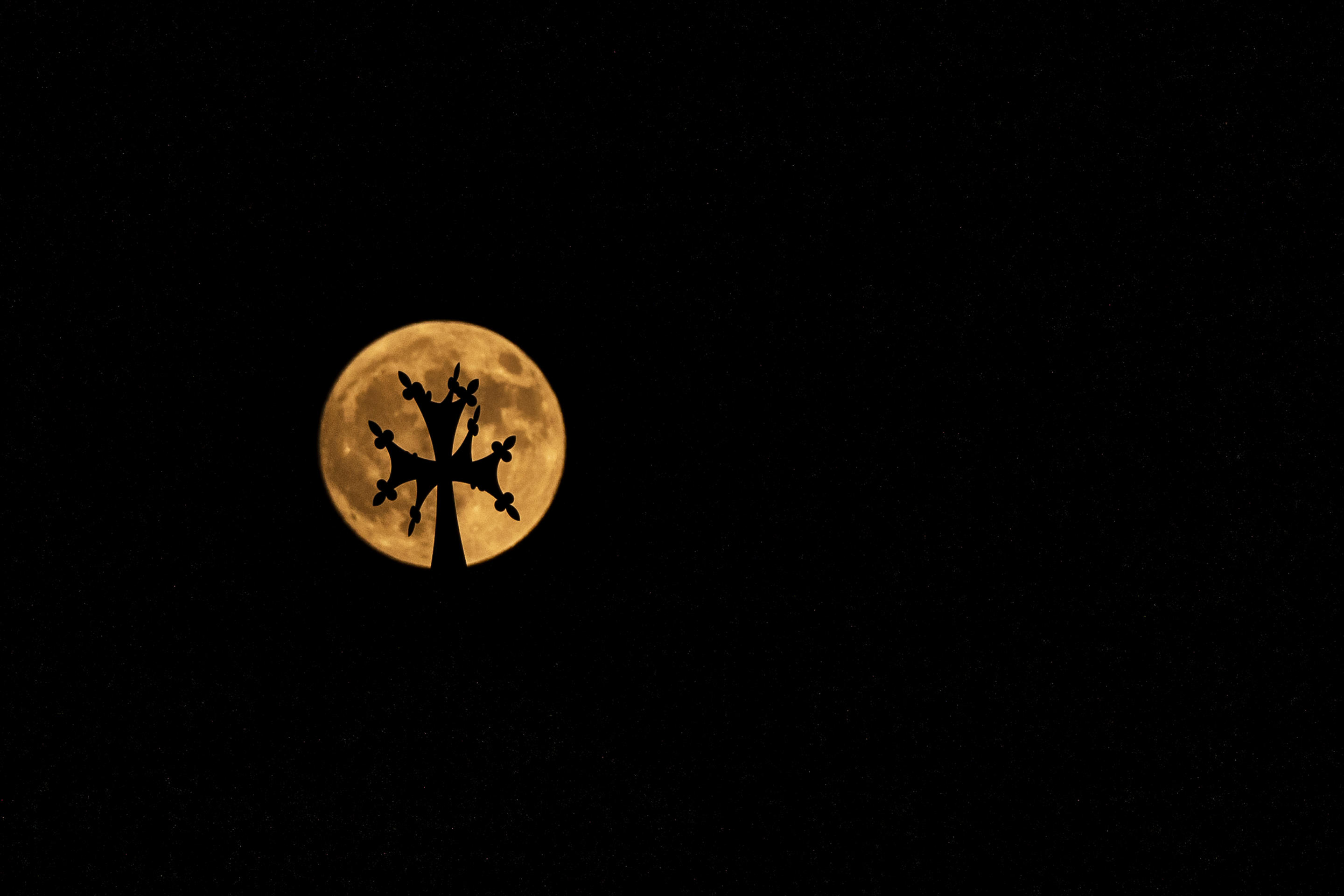 The supermoon rises beyond the cross atop Saint Elias and Saint Gregory the Illuminator Armenian Catholic Cathedral, in Beirut, Lebanon, Sept. 17. (Hassan AmmarAP)