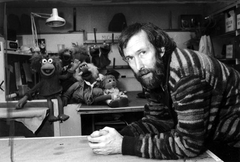 FILE- In this Feb. 6, 1984, file photo, Jim Henson with his "Muppets" pose for a photo at Henson's 69th Street office in New York. A New York City museum is asking fans of Jim Henson's Muppets to help pay for an exhibition featuring original puppets of beloved characters like Elmo, Miss Piggy and Kermit the Frog. The Museum of the Moving Image launched a Kickstarter campaign Tuesday, April 11, 2017, seeking $40,000 to help preserve the puppets for posterity. (AP Photo/G. Paul Burnett, File)