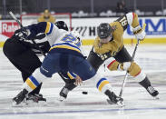 St. Louis Blues center Tyler Bozak (21) and Vegas Golden Knights center Jonathan Marchessault (81) face off during the second period of an NHL hockey game Saturday, May 8, 2021, in Las Vegas. (AP Photo/David Becker)