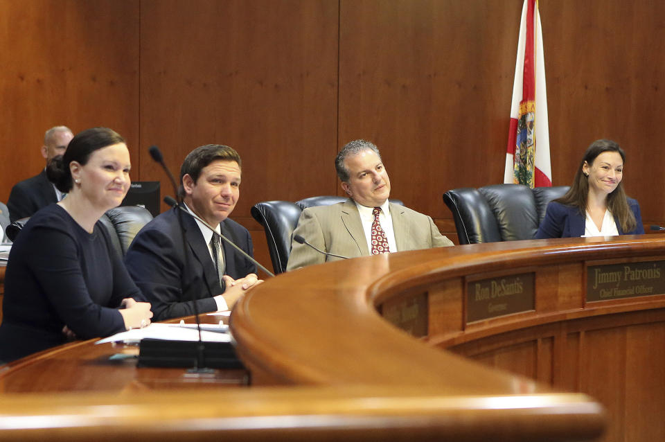 Gov. Ron DeSantis, second from left, presides over a Florida cabinet meeting in June 2019 in Tallahassee.