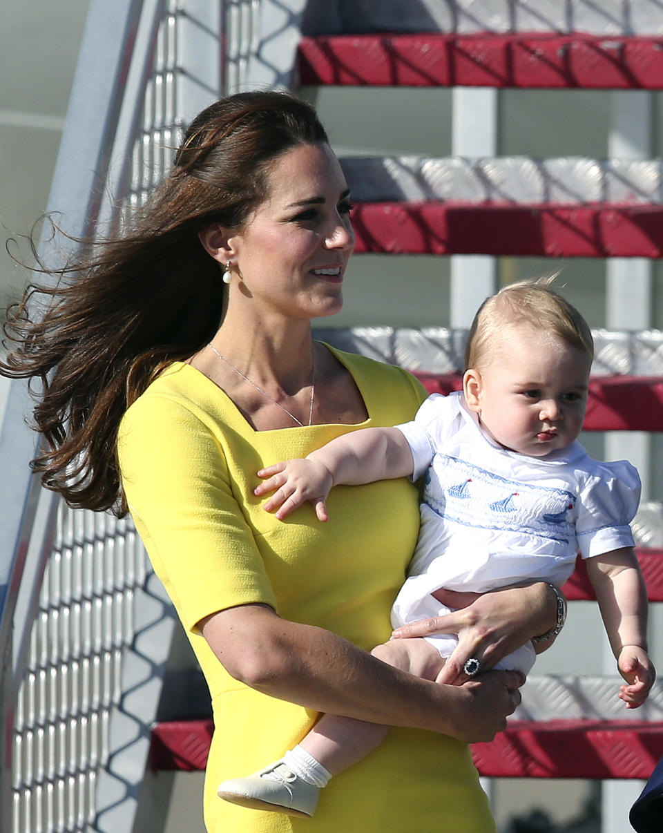 Britain's Kate, the Duchess of Cambridge, and Prince George arrive in Sydney, Australia, Wednesday, April 16, 2014. The Duke and Duchess of Cambridge are on a three-week tour of Australia and New Zealand, the first official trip overseas with their son, Prince George. (AP Photo/Rob Griffith)