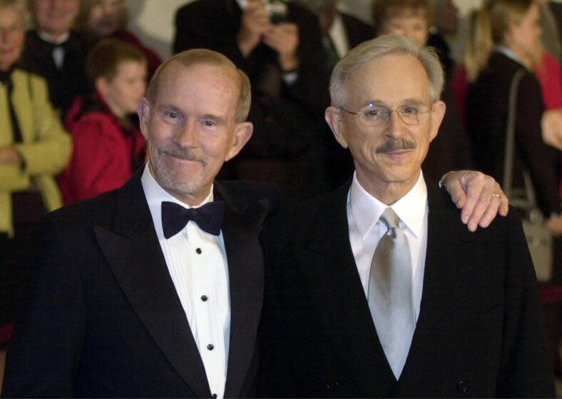 FILE - This Oct. 29, 2002 file photo shows The Smothers Brothers, Tom Smothers, left, and Dick Smothers at the Kennedy Center in Washington for the Mark Twain Prize for Humor Award ceremony honoring Bob Newhart. The duo has stepped out of retirement to commemorate the day 50 years ago when CBS canceled their show over their political impudence. The pair reunited Monday, July 29, 2019, for several appearances at the National Comedy Center in Jamestown, New York. (AP Photo/Lawrence Jackson, File)
