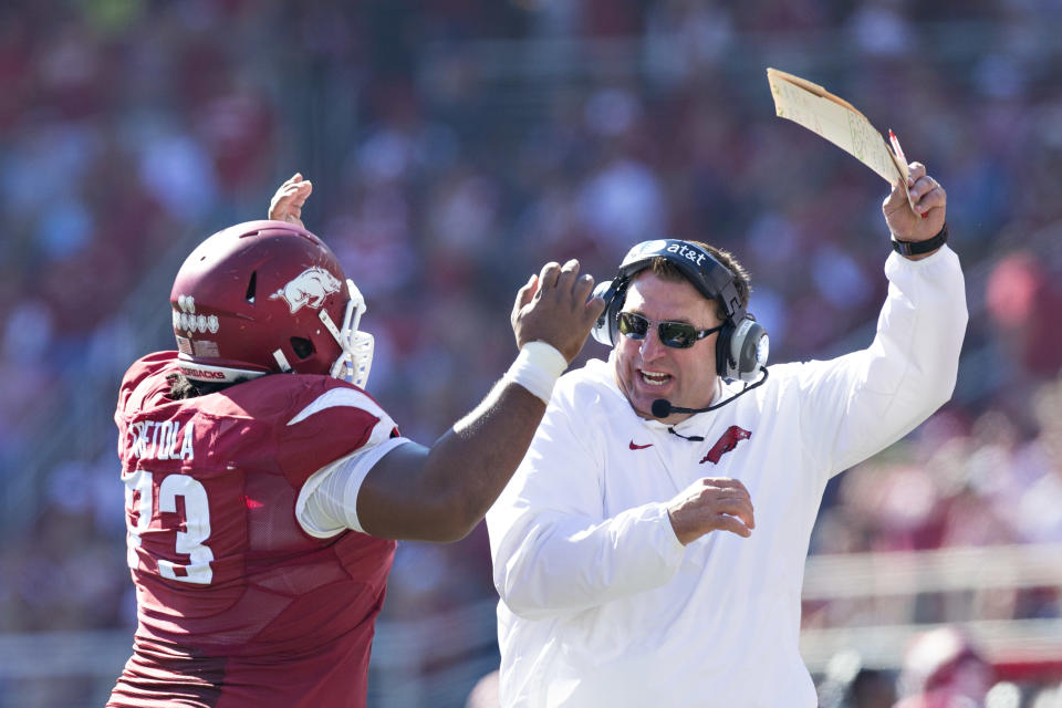FAYETTEVILLE, AR – OCTOBER 25: Head Coach Bret Bielema and <a class="link " href="https://sports.yahoo.com/nfl/players/29427" data-i13n="sec:content-canvas;subsec:anchor_text;elm:context_link" data-ylk="slk:Sebastian Tretola;sec:content-canvas;subsec:anchor_text;elm:context_link;itc:0">Sebastian Tretola</a> #73 of the Arkansas Razorbacks celebrate after Tretola throws a touchdown pass against the UAB Blazers at Razorback Stadium on October 25, 2014 in Fayetteville, Arkansas. (Photo by Wesley Hitt/Getty Images)
