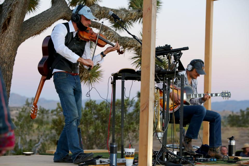 Jazz violinist Jeremie Levi Samson, right, and guitarist Micha Schellhaas perform during a live music drive-in at Mon Petit Mojave in Yucca Valley, Calif., on Sunday, June 7, 2020. 