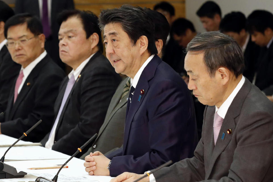 Japanese Prime Minister Shinzo Abe, second from right, speaks during a meeting on countermeasures against the new coronavirus infections at his official residence in Tokyo Thursday, March 5, 2020. Abe said visitors from China and South Korea would need to complete a two-week quarantine at a government facility and be barred from public transit. (Yukie Nishizawa/Kyodo News via AP)