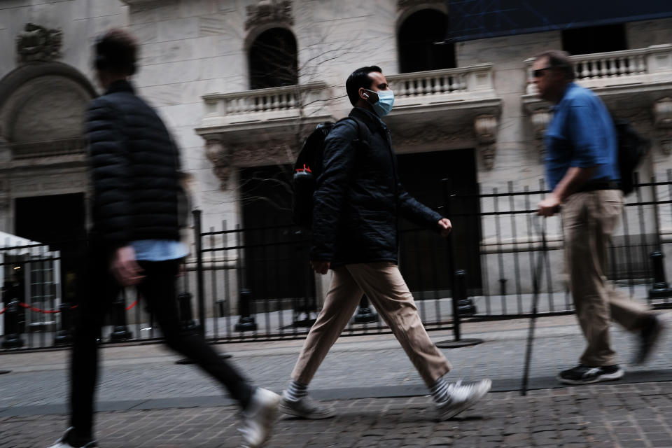 NEW YORK, NEW YORK - MARCH 10: A man in a medical mask walks by the New York Stock Exchange (NYSE) on March 10, 2020 in New York City. After losing nearly 8 percent in a market rout yesterday, the Dow Jones Industrial Average was up over 700 points in morning trading as investors look to a possible tax cut and other measures by the Trump administration to combat the coronavirus. (Photo by Spencer Platt/Getty Images)