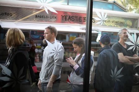 FILE PHOTO: Customers queue for recreational marijuana outside the MedMen store in West Hollywood, California U.S. January 2, 2018. REUTERS/Lucy Nicholson/File Photo