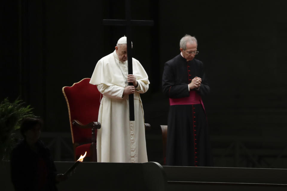 Pope Francis holds the cross during the Via Crucis – or Way of the Cross – ceremony in front of St. Peter's Basilica, empty of the faithful following Italy's ban on gatherings during a national lockdown to contain contagion, at the Vatican, Friday, April 10, 2020. (AP Photo/Andrew Medichini, Pool)