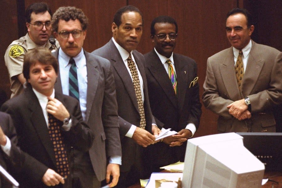 FILE – Defendant O.J. Simpson and members of his defense team react as the jury, many wearing white T-shirts sporting a slogan from a local pizza chain, walk into the courtroom in Los Angeles Friday, May 5, 1995. From left to right are” Barry Scheck, Peter Neufeld, O.J. Simpson, Johnnie Cochran Jr., and Robert Shapiro. Background is Deputy Guy Magnera. Simpson, the decorated football superstar and Hollywood actor who was acquitted of charges he killed his former wife and her friend but later found liable in a separate civil trial, has died. He was 76. (AP Photo/Reed Saxon, Pool, File)