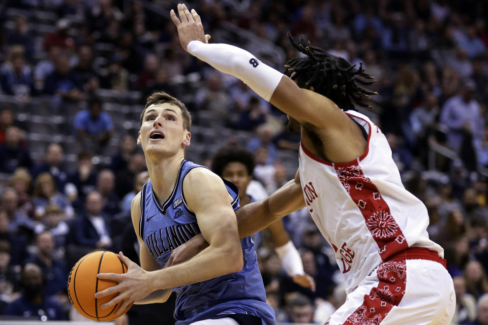 Villanova guard Chris Arcidiacono drives to the basket past Boston College forward T.J. Bickerstaff during the second half of an NCAA college basketball game Saturday, Dec. 10, 2022, in Newark, N.J. Villanova won 77-56. (AP Photo/Adam Hunger)