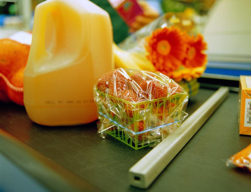 groceries divided by bar on supermarket check out conveyer belt