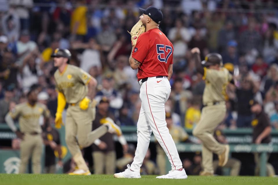 Boston Red Sox relief pitcher Greg Weissert (57) reacts after giving up a three-run home run to San Diego Padres' Jackson Merrill, second from left, during the fifth inning of a baseball game, Friday, June 28. 2024, in Boston. (AP Photo/Michael Dwyer)