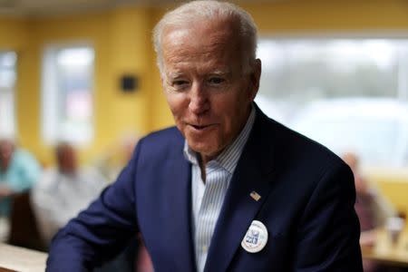 2020 Democratic U.S. presidential candidate and former Vice President Joe Biden talks to reporters after ordering an ice cream cone at the Cone Shoppe during a two-day campaign kickoff in Monticello, Iowa, U.S. April 30, 2019. REUTERS/Jonathan Ernst