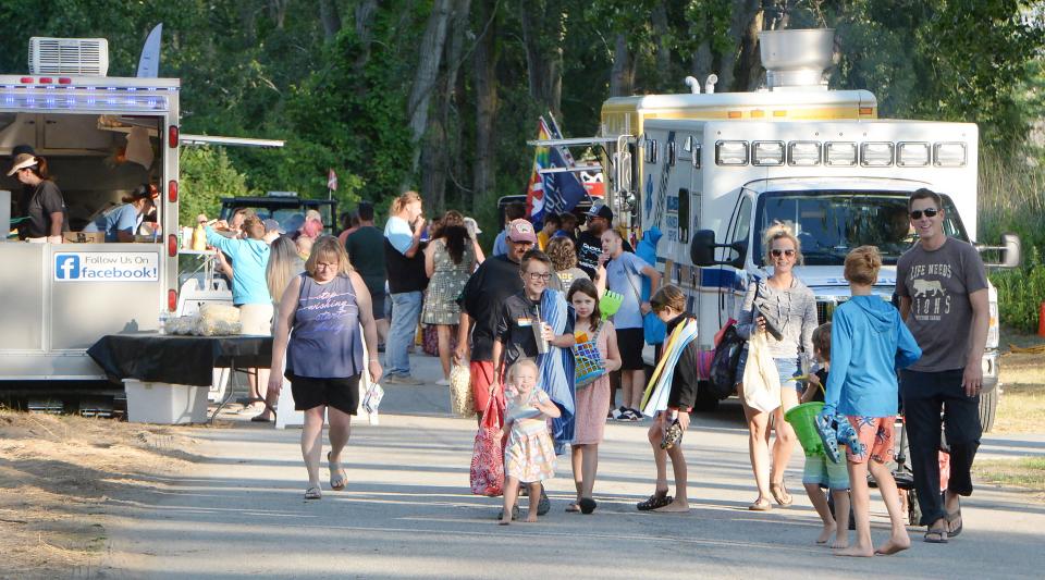 Food trucks and vendors serve customers near Presque Isle State Park's Beach 11 during a Sunset Music Series concert on July 13, 2022. The park is seeking mobile food and refreshment vendors to operate on a daily basis in summer.