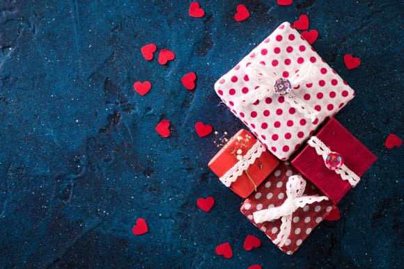 Four wrapped presents surrounded by hearts.