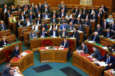 Hungarian Prime Minister Viktor Orban casts his vote on a bill tightening regulations on foreign universities operating in Hungary, effectively pushing out of the country Central European University, a school founded by U.S. billionaire philanthropist George Soros, in Budapest, Hungary, April 4, 2017. REUTERS/Laszlo Balogh