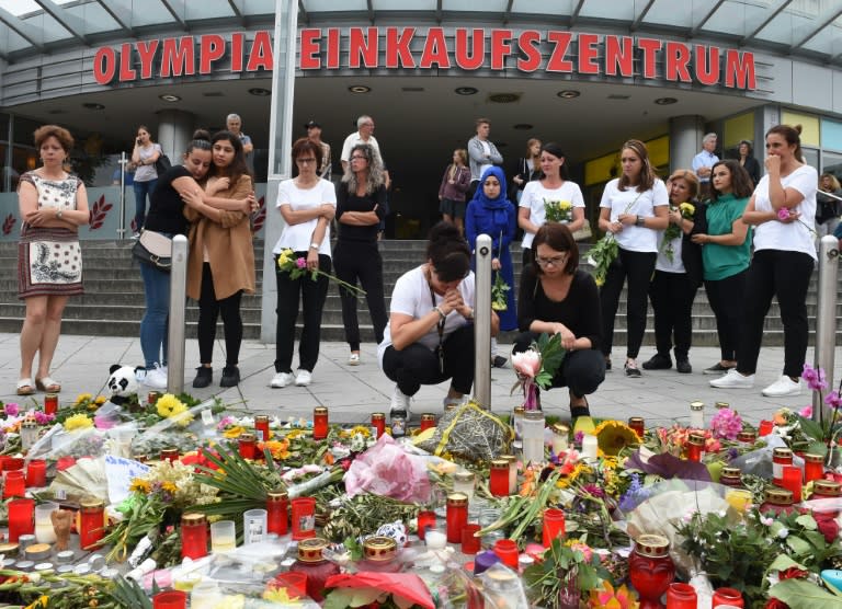 Candles and flowers pile up near the Olympia shopping mall in Munich where an 18-year-old German-Iranian student went on a shooting rampage