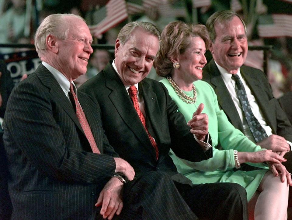 Bob and Elizabeth Dole with George H.W. Bush in Grand Rapids, Michigan, on Nov. 1, 1996.