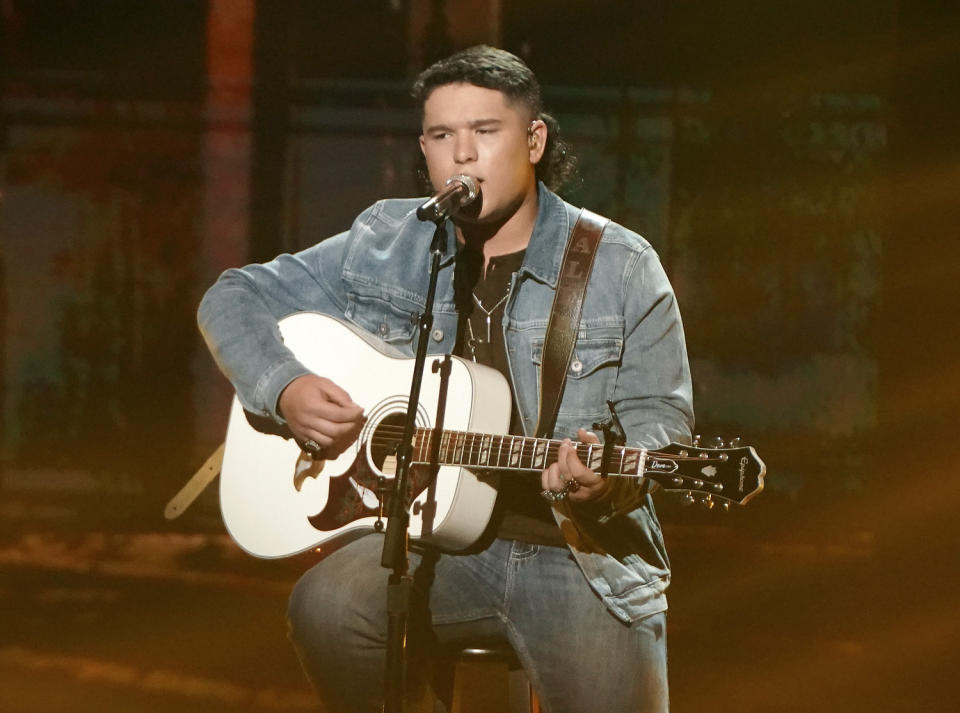 This image released by ABC shows Caleb Kennedy performing on the singing competition series "American Idol," in Los Angeles that aired May 9. Kennedy has dropped out of the singing competition after a video circulated showing him sitting next to someone wearing what appears to be a Ku Klux Klan hood. Kennedy, advanced into the Top 5, apologized for the video on Twitter and Instagram on Wednesday, saying “it displayed actions that were not meant to be taken in that way.” (Eric McCandless/ABC via AP)