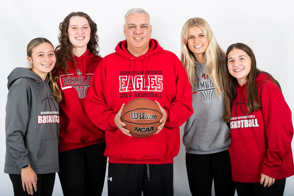 Bermudian Springs basketball head coach Todd Askins poses for a photo with players (from left) Ella Benzel, Lucy Peters, Tori Bross and Hannah Metzger during YAIAA winter sports media days Thursday, November 9, 2023, in York.