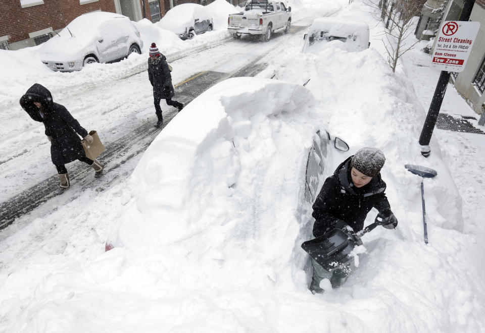 FILE - Taylor LaBrecque, below right, shovels her car out of a snow pile, Monday, Feb. 9, 2015, in the Beacon Hill neighborhood, of Boston. For much of the Eastern United States, the winter of 2023 has been a bust. Snow totals are far below average from Boston to Philadelphia in 2023 and warmer temperatures have often resulted in more spring-like days than blizzard-like conditions. (AP Photo/Steven Senne, File)