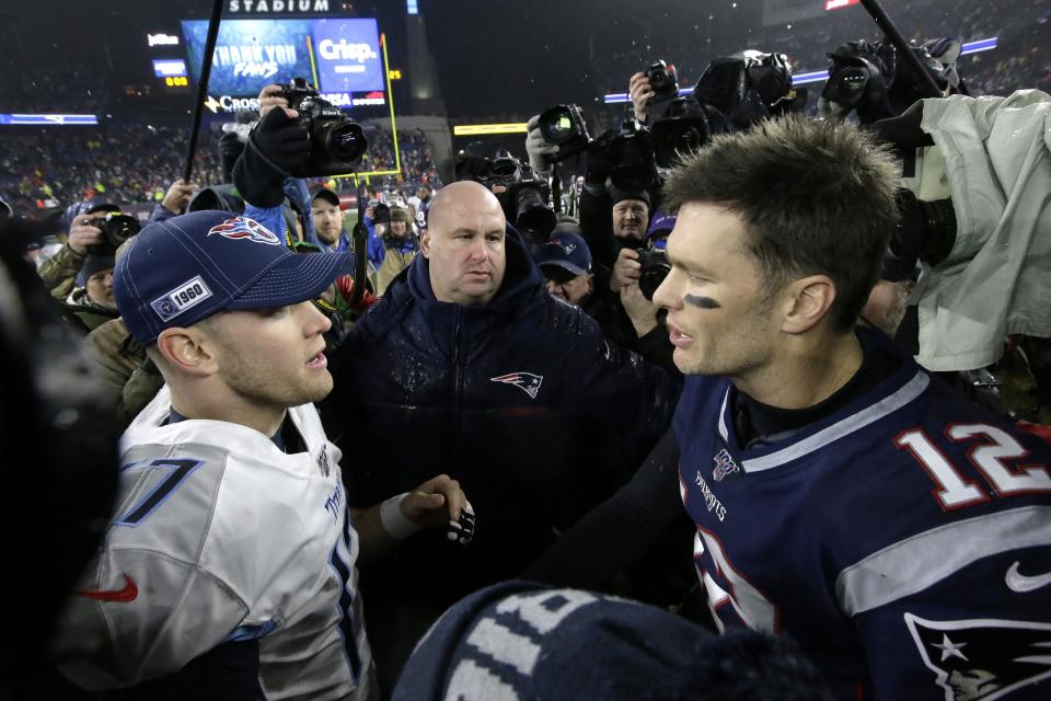 Tennessee Titans quarterback Ryan Tannehill, left, and New England Patriots quarterback Tom Brady speak at midfield after an NFL wild-card playoff football game, Saturday, Jan. 4, 2020, in Foxborough, Mass. (AP Photo/Steven Senne)