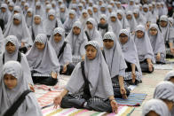 Indian students practice yoga ahead of International Yoga Day at a school in Ahmadabad, India, Tuesday, June 18, 2019. International Yoga Day will be celebrated on June 21. (AP Photo/Ajit Solanki)