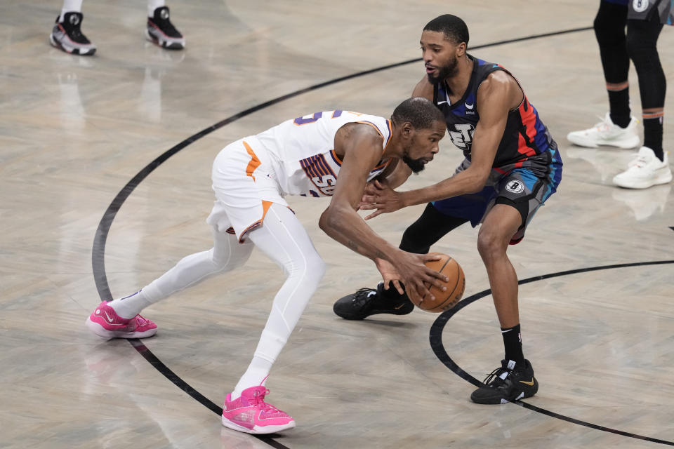 Phoenix Suns forward Kevin Durant, left, drives against Brooklyn Nets forward Mikal Bridges during the first half of an NBA basketball game, Wednesday, Jan. 31, 2024, in New York. (AP Photo/Mary Altaffer)