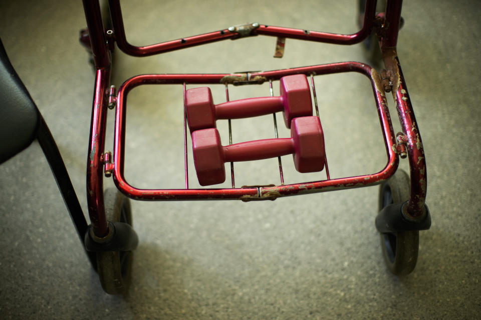 Weights belonging to Maksym, a resident in a facility for people with mental and physical disabilities, rest in his wheeled walking aid in his bedroom in the village of Tavriiske, Ukraine, Wednesday, May 11, 2022. With around 425 residents, the institution is the largest such facility for people with disabilities in southeastern Ukraine's Zaporizhzhia region. (AP Photo/Francisco Seco)