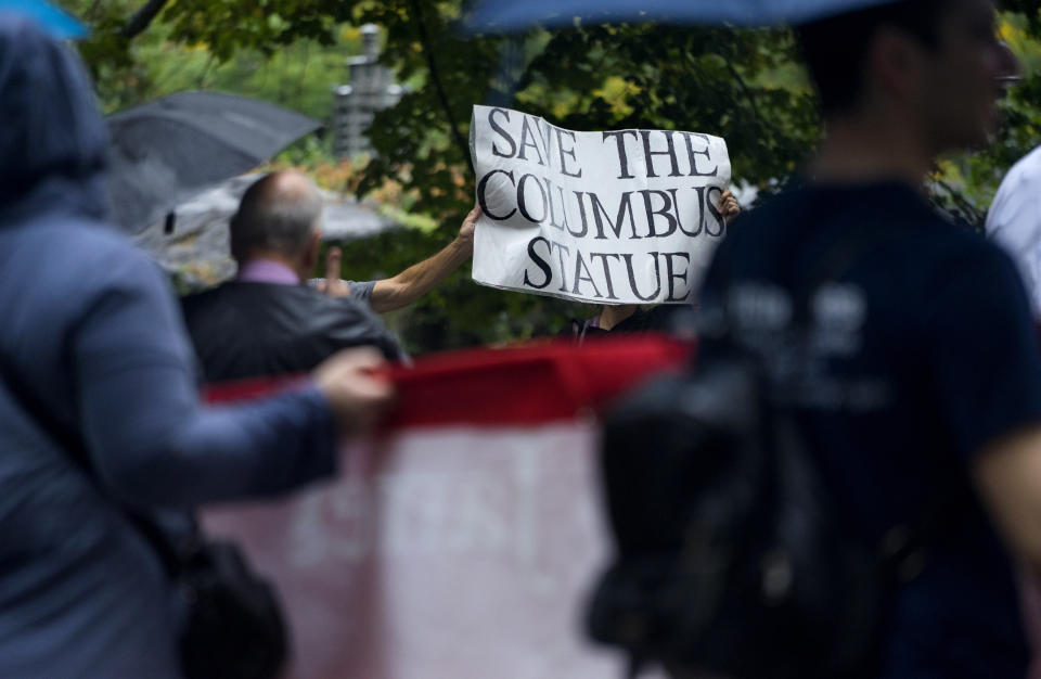 <p>Activists standing along Fifth Ave. display a sign during the annual Columbus Day Parade in New York, Monday, Oct 9, 2017. (Photo: Craig Ruttle/AP) </p>