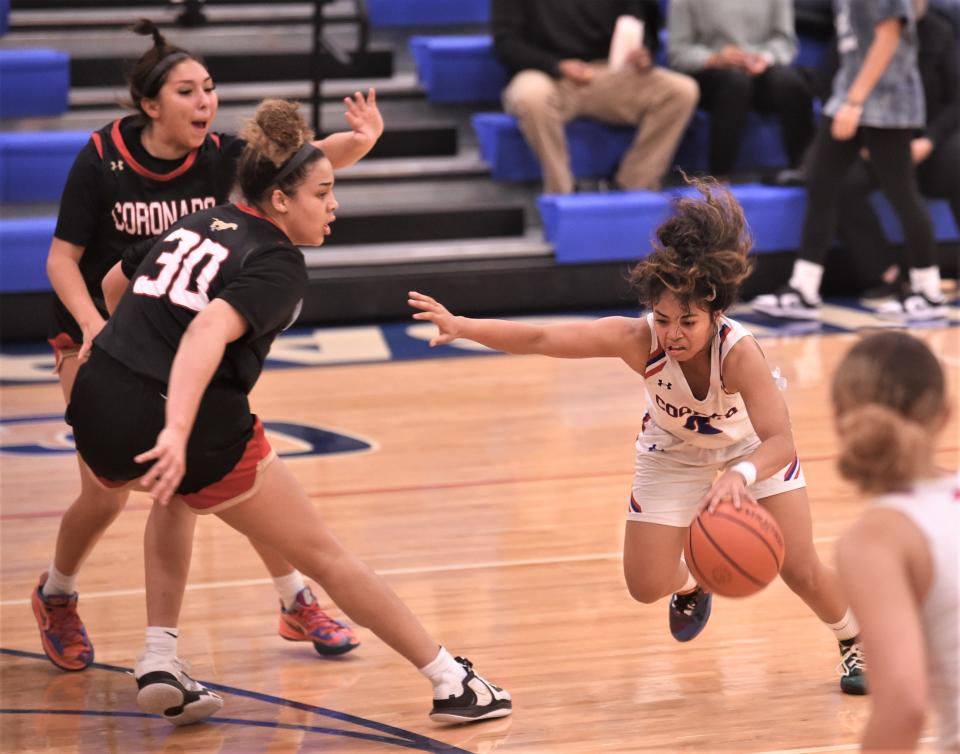 Cooper's Alliyah Ralston tries to get around Lubbock Coronado's Kya Smith (30) in the first half.
