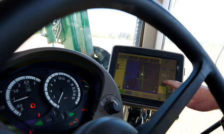 An employee of the "Poschinger Bray'sche Gueterverwaltung" company controls a tractor equipped with an iTC receiver (used for parallel driving) at a field in Irlbach near Deggendorf, Germany, April 21, 2016. REUTERS/Michaela Rehle