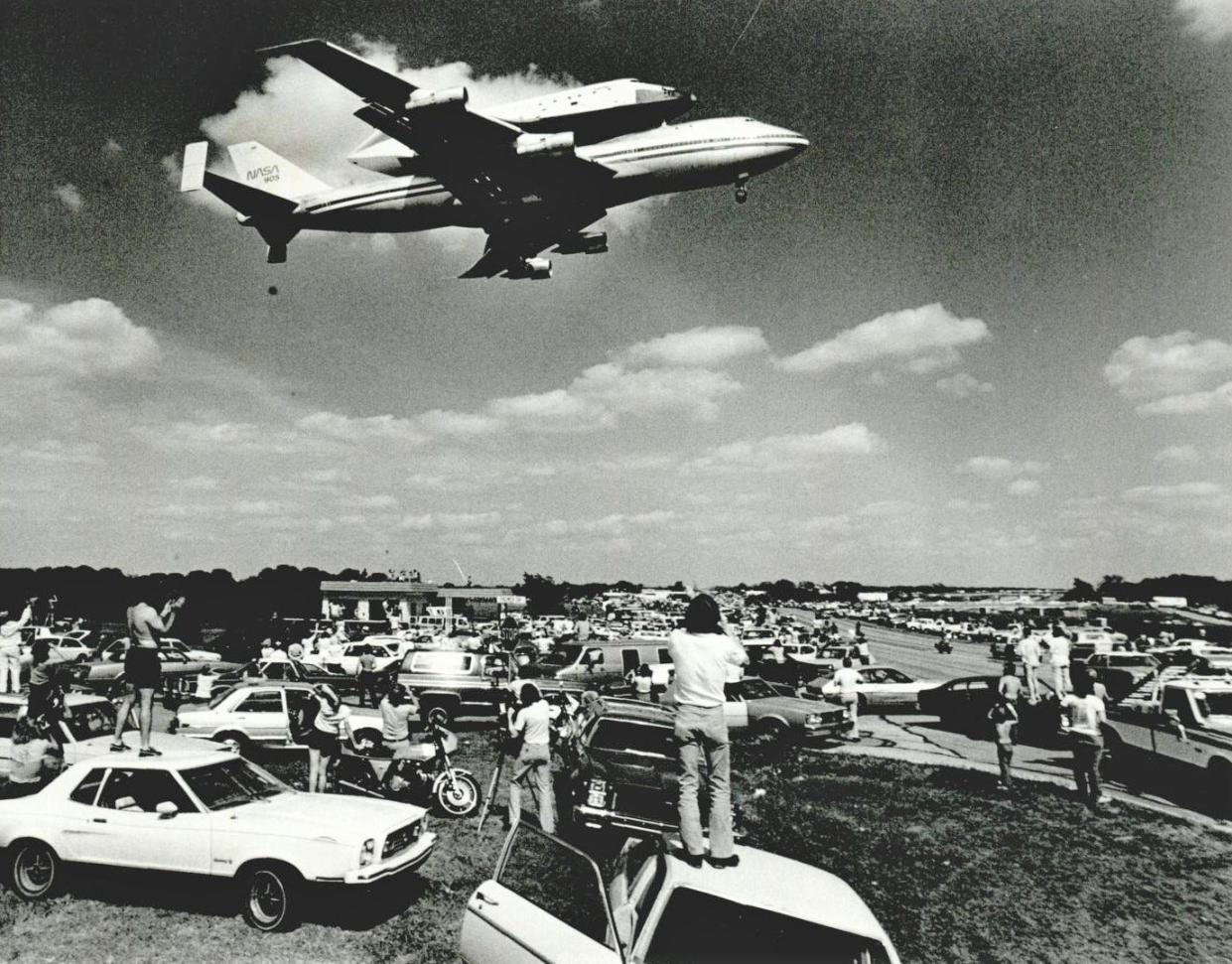 A crowd of spectators along SE 29 and I-40 watch as the space shuttle Columbia flies piggyback atop a modified Boeing 747 jet. This photo was published on Page 1 of The Daily Oklahoman on April 28, 1981, the day after the aircrafts had landed at Tinker Air Force Base for refueling and public viewing. An estimated 200,000 people came to see Columbia, which had been the first space shuttle to reach space on April 12 that same year. More than two decades later and after completing 27 successful missions, the Columbia space shuttle broke apart on Feb. 1, 2003, while re-entering the Earth's atmosphere, killing all seven astronauts aboard.