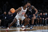 Virginia Tech's Justyn Mutts (25) drives past Xavier's Paul Scruggs during the first half of an NCAA college basketball game in the NIT Season Tip-Off tournament Friday, Nov. 26, 2021, in New York. (AP Photo/Adam Hunger)